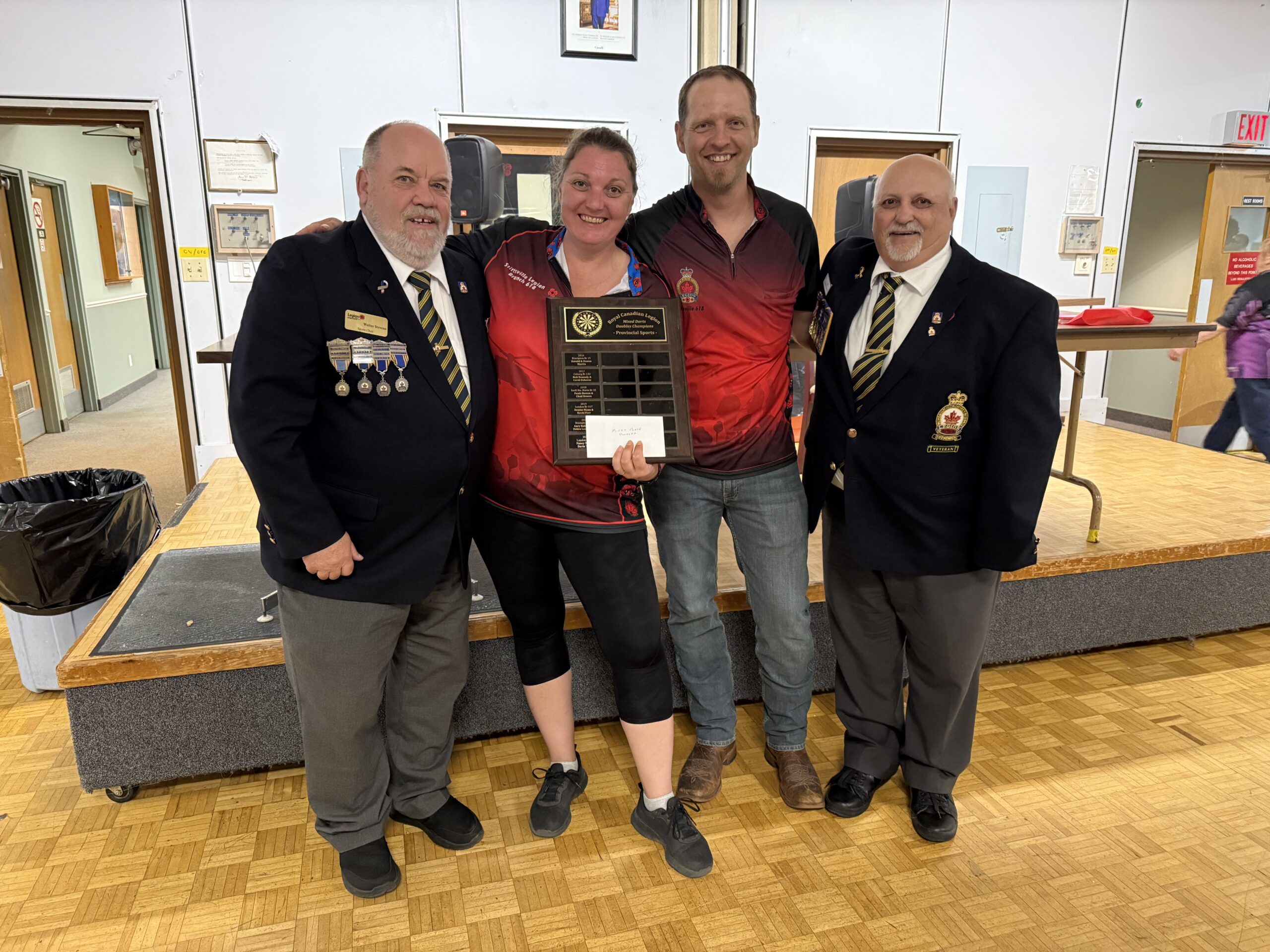 Walter Stevens, Provincial Sports Chair (on the left) Darts Mixed Doubles winners from Br. 618 Stittsville Tracy Boss & Lyle Stamplecoski. Len Droullard, District A Sports Chair is on the right.